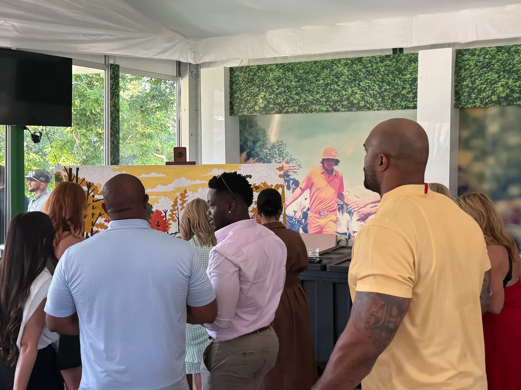 Guests gathered around a golf-themed paint-by-number mural at Muirfield Village