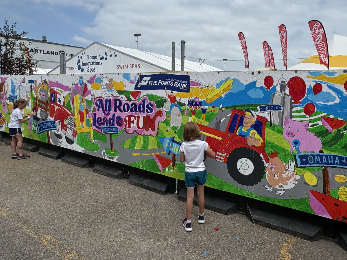 Attendees painting a custom paint by number mural at a corporate event